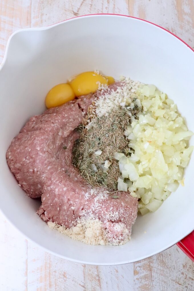 ingredients for turkey meatballs separated in a large mixing bowl