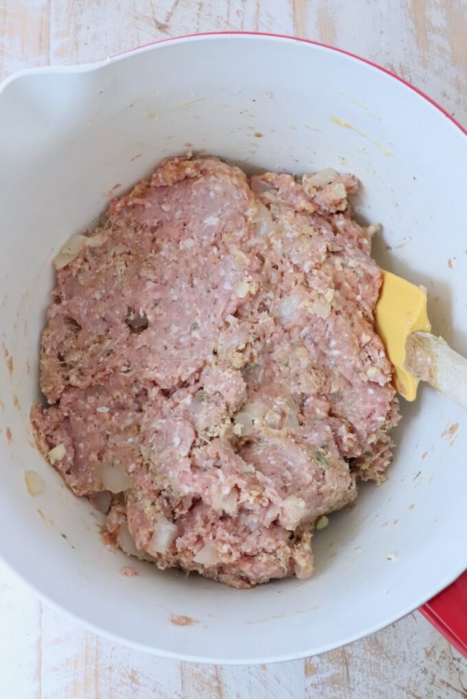 ingredients for turkey meatballs combined in a large mixing bowl