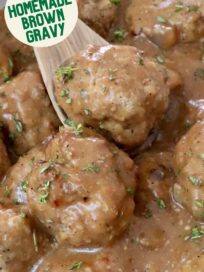 turkey meatballs in gravy in a bowl with a spoon