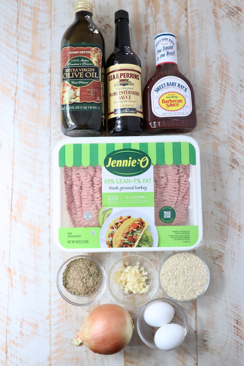 ingredients for turkey meatloaf on a white wood board