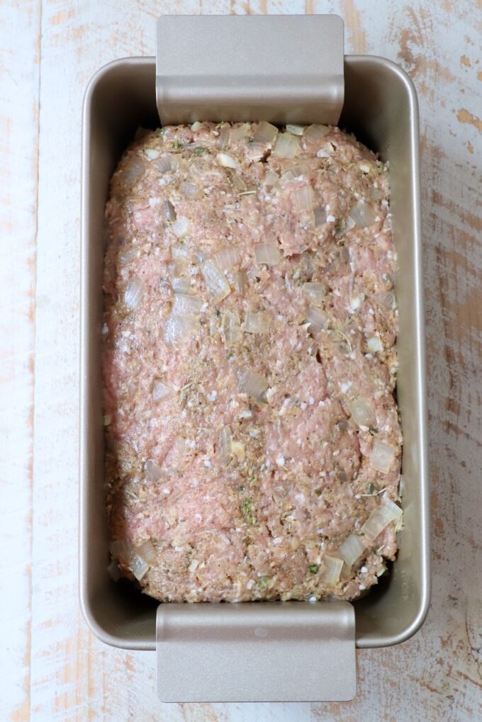 uncooked meatloaf pressed into a loaf pan