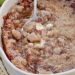 baked apple pie dip in a baking dish with a serving spoon