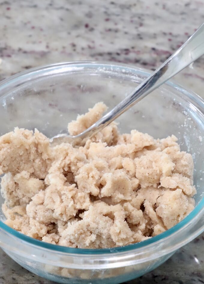 cinnamon sugar crumble in a glass bowl with a fork