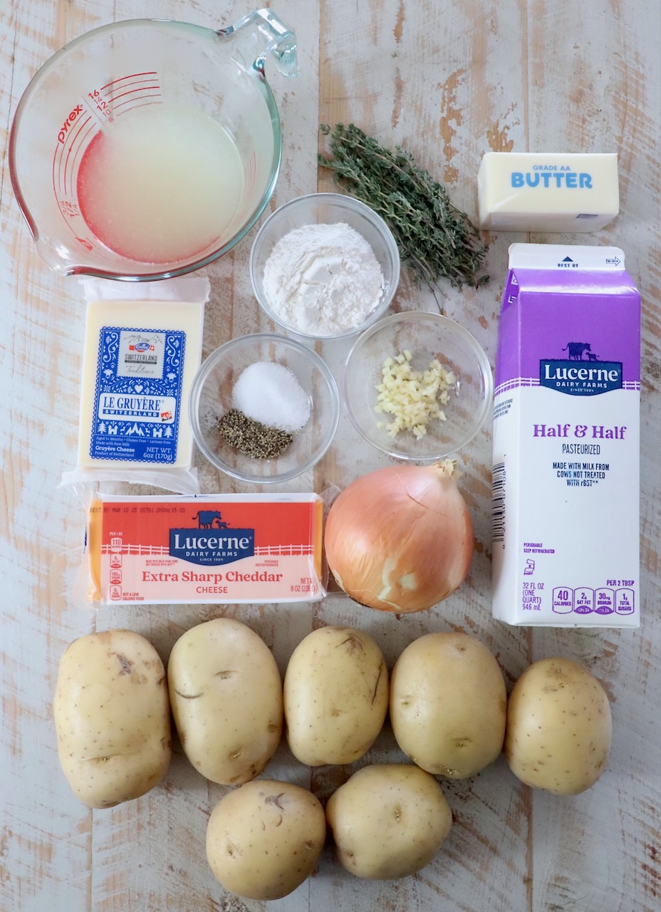 ingredients for au grain potatoes on a white wood board