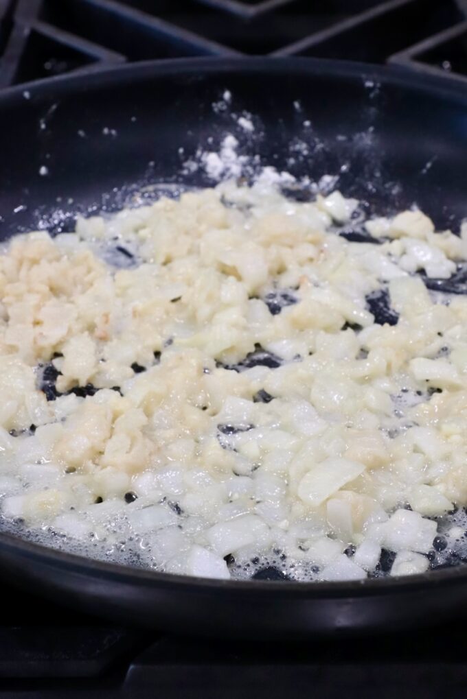 diced onions and garlic in a skillet with flour