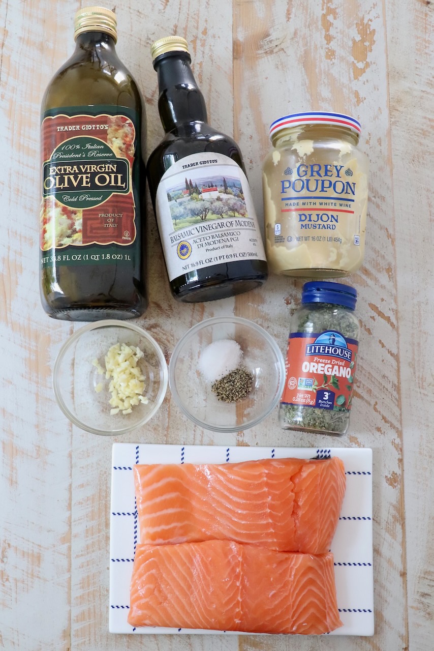 ingredients for balsamic glazed salmon on a white wood board