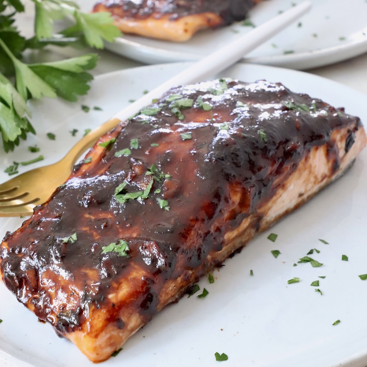 balsamic glazed salmon on a plate with a fork