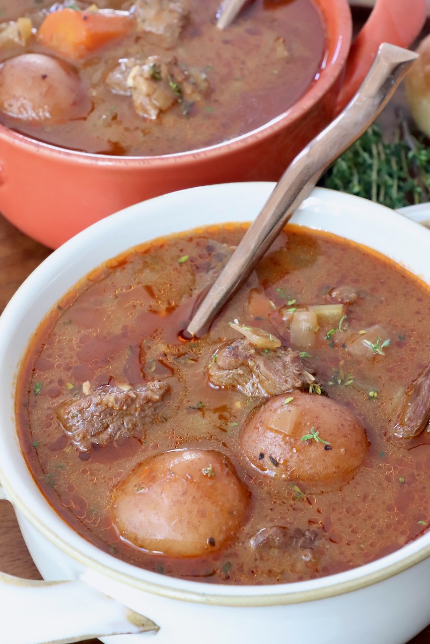 beef stew in two bowls with spoons