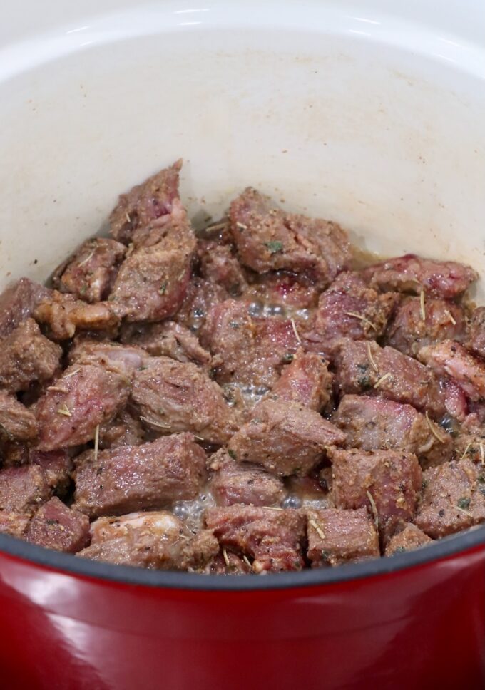 seared, seasoned, cubed beef in a large dutch oven