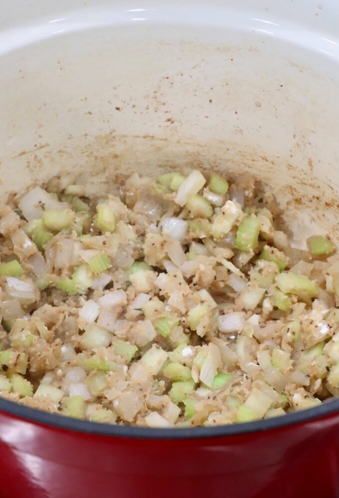 diced onions and celery in a dutch oven with flour and broth