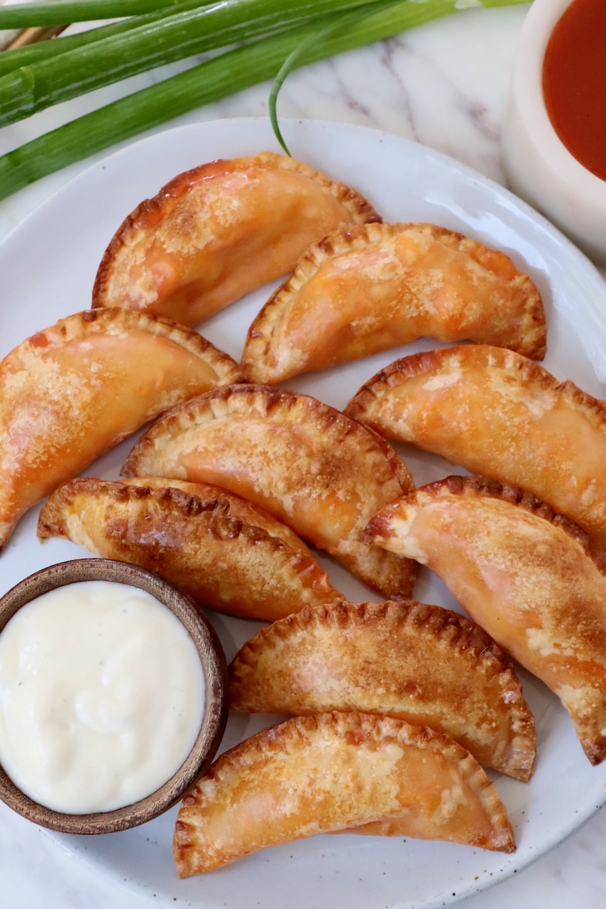 buffalo chicken bites on a plate with a small bowl of blue cheese dressing