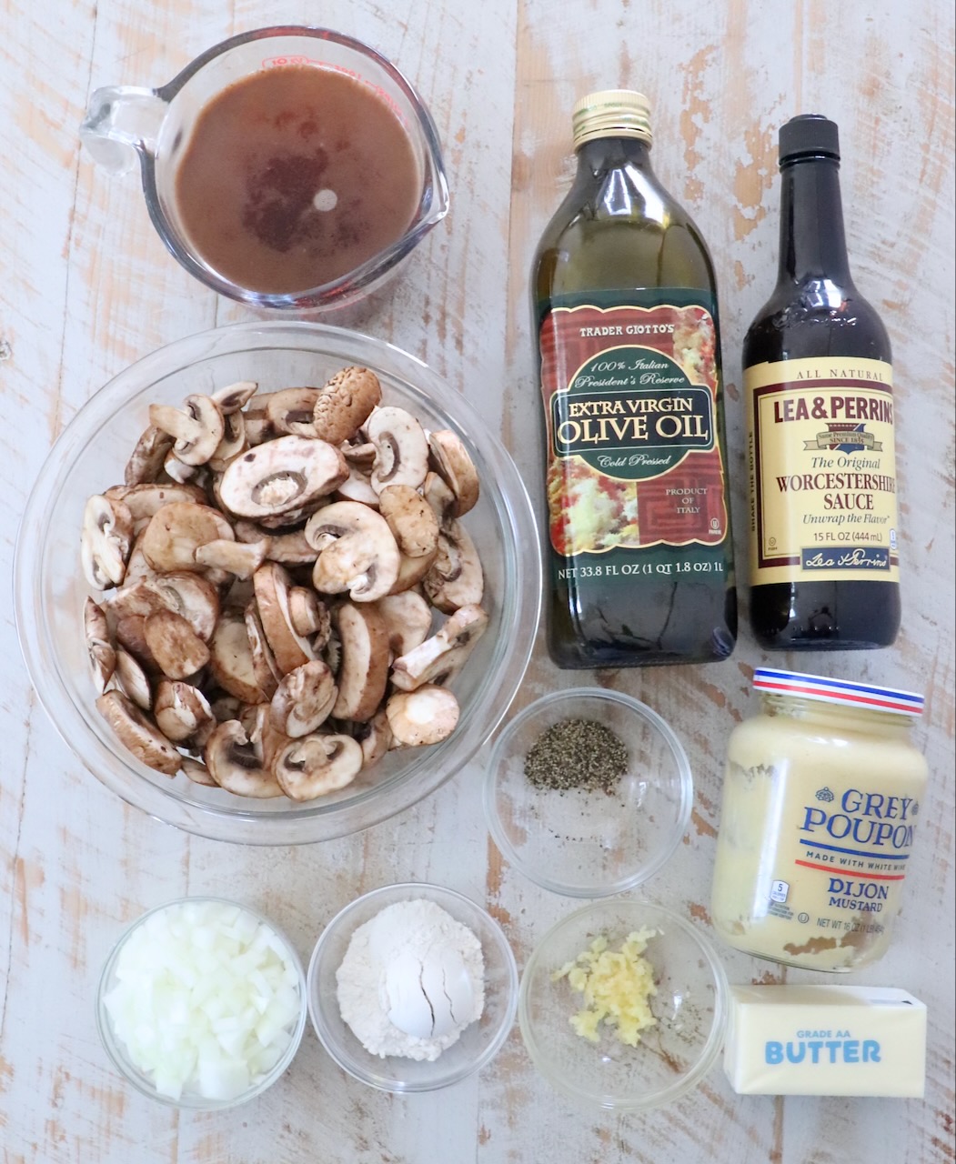 ingredients for mushroom gravy on a white wood board