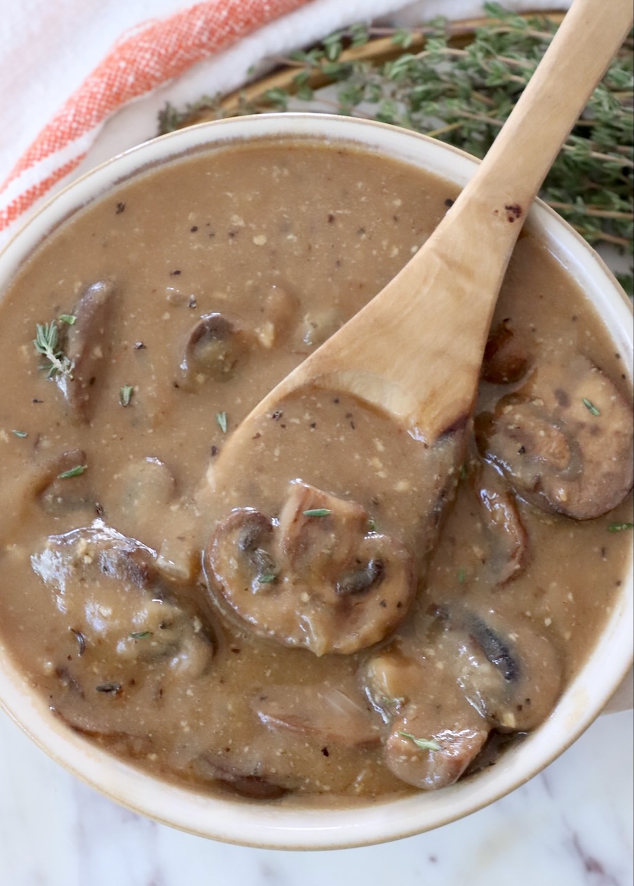 mushroom gravy in a bowl with a spoon