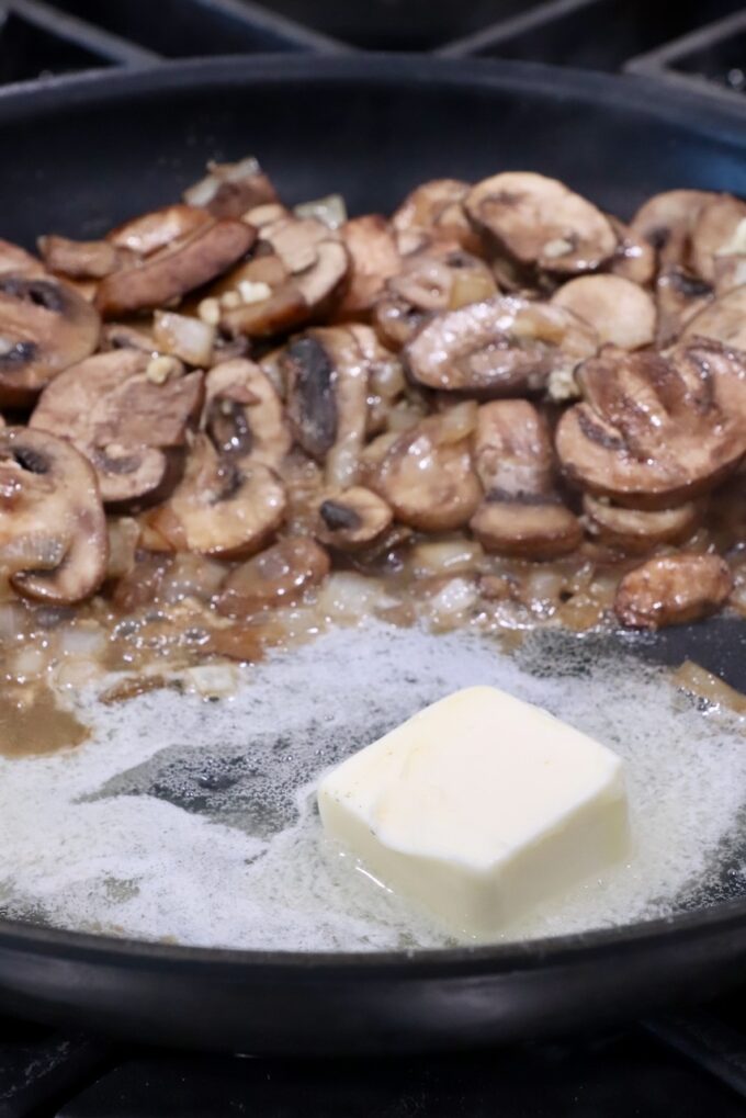 melted butter in a large skillet with sliced mushrooms