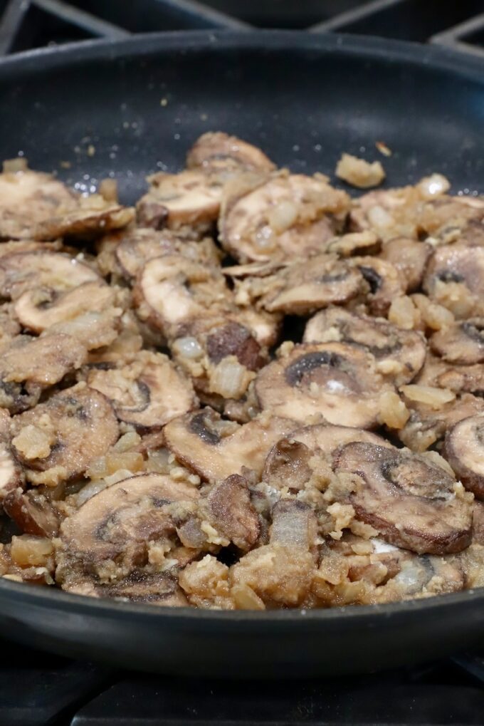 sliced mushrooms combined with a roux in a large skillet