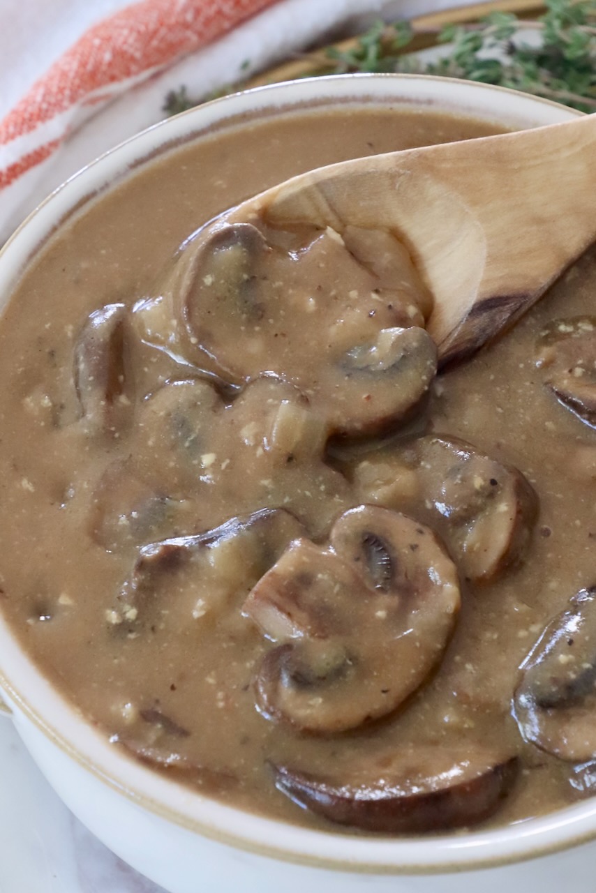 mushroom gravy in a bowl with a spoon