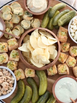 pickle board filled with dips, snacks and pickles