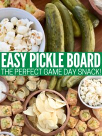 pickles and snacks on a wood board