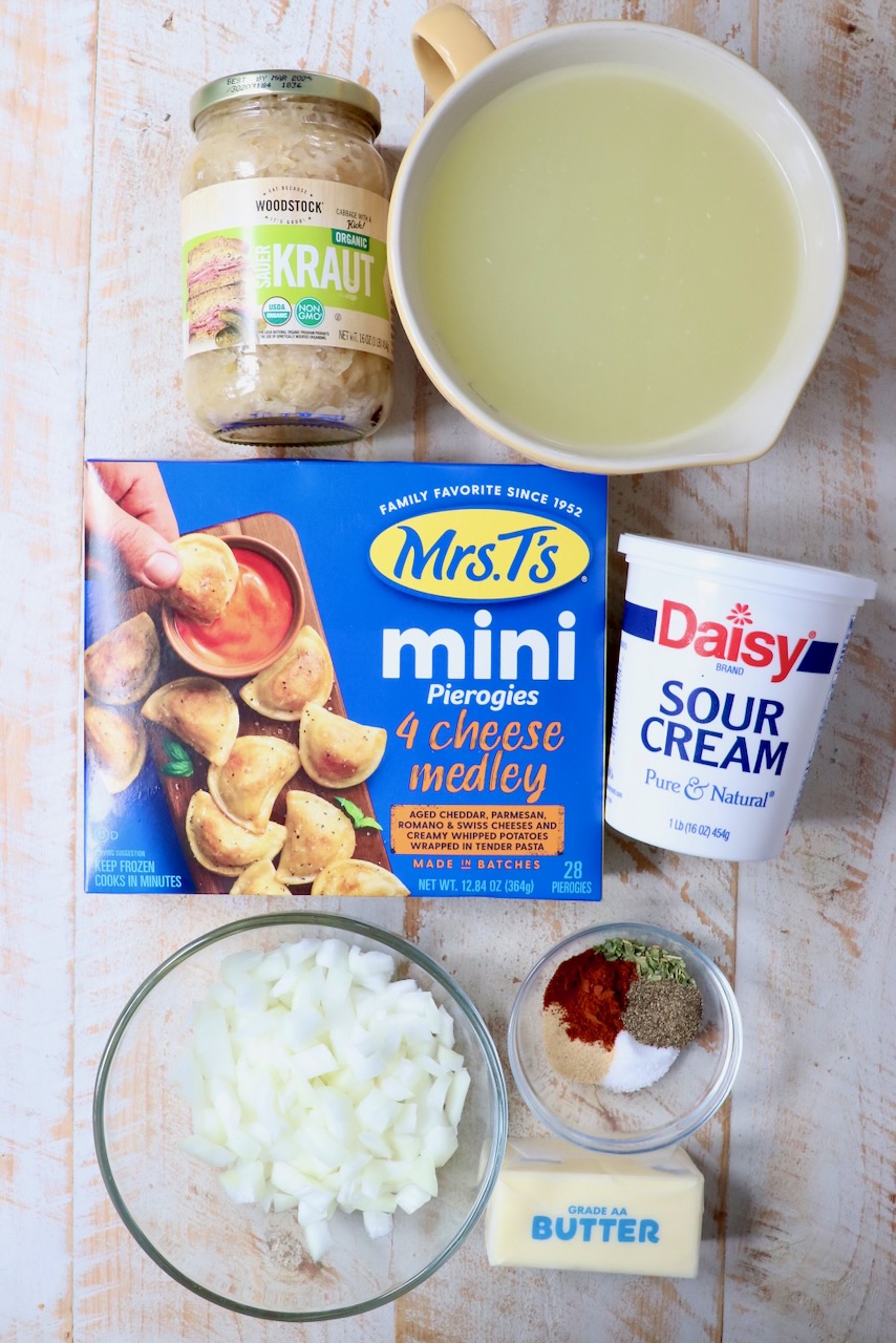 ingredients for pierogi soup on a white wood board