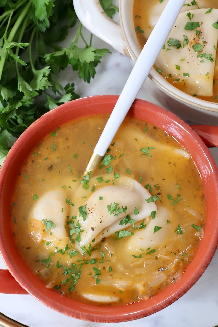 pierogi soup in bowls with a spoon