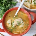 pierogi soup in bowl with a spoon