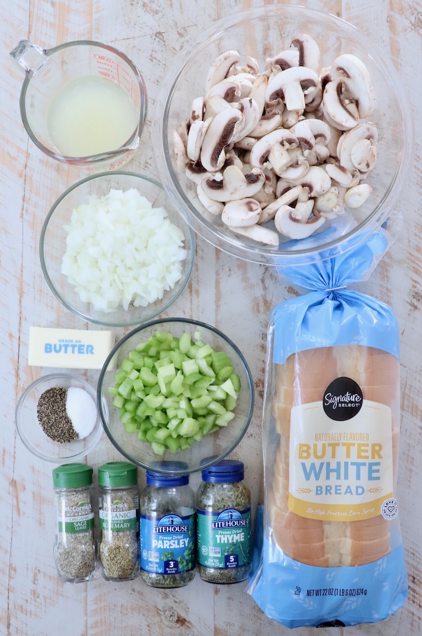 ingredients for mushroom stuffing on a white wood board