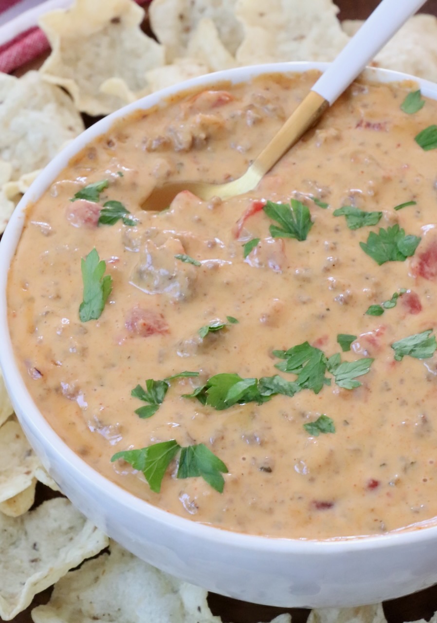 rotel queso dip in a bowl with a spoon