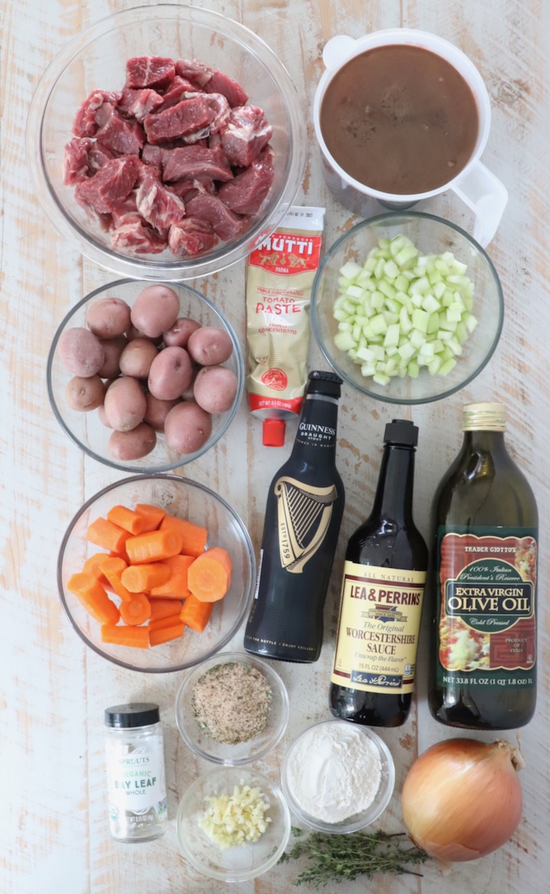 ingredients for Irish stew on a white wood board