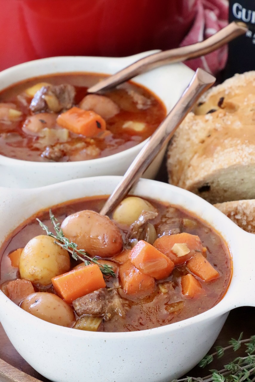 Irish stew in two bowls with spoons