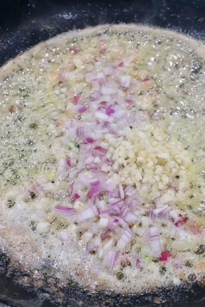 diced shallots and garlic in a skillet with melted butter