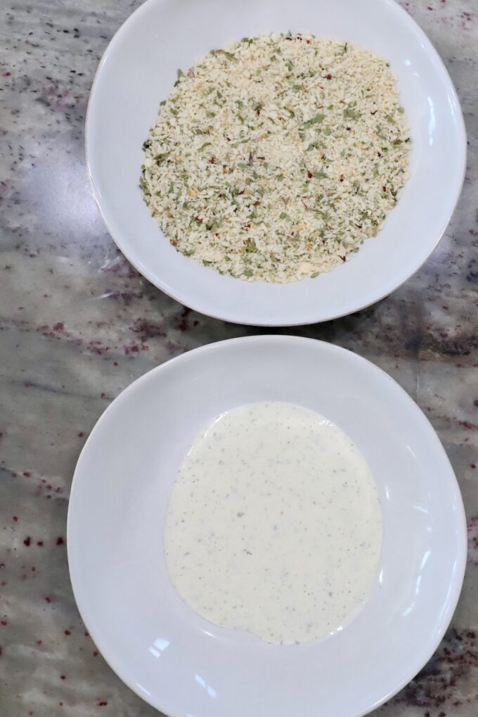 ranch dressing in bowl, next to seasoned breadcrumbs in a bowl