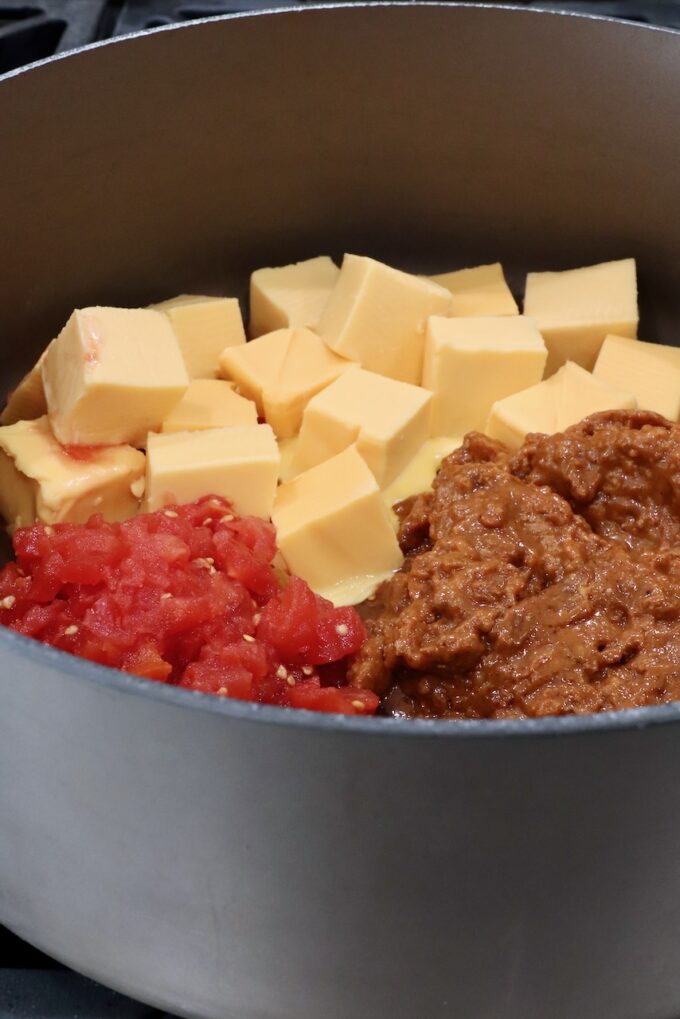 cubed velveeta cheese, diced tomatoes and chili in a large pot