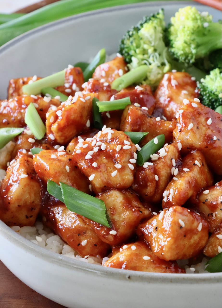 prepared gochuhang chicken in a bowl with broccoli and rice