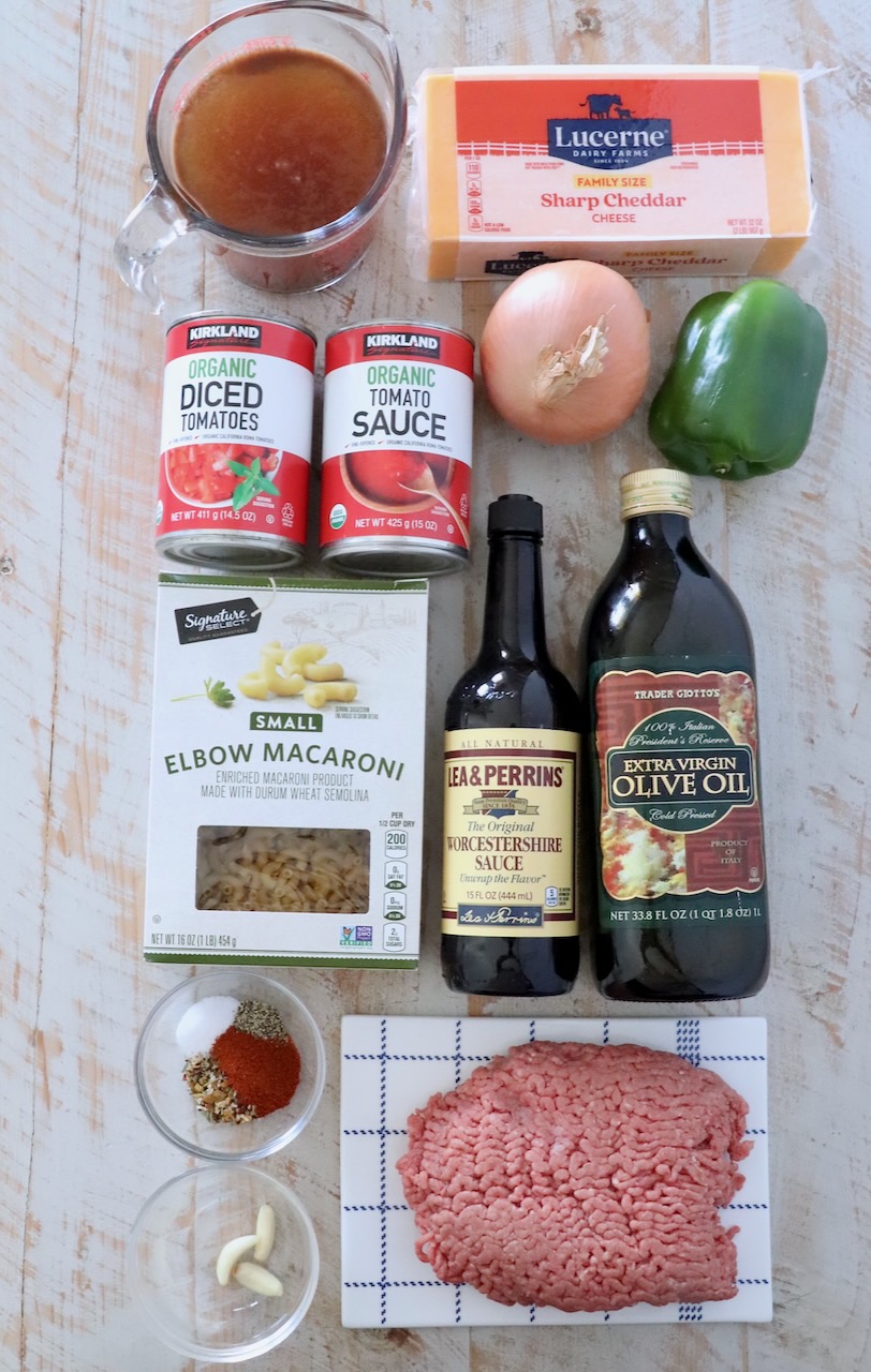 ingredients for American goulash on a white wood board