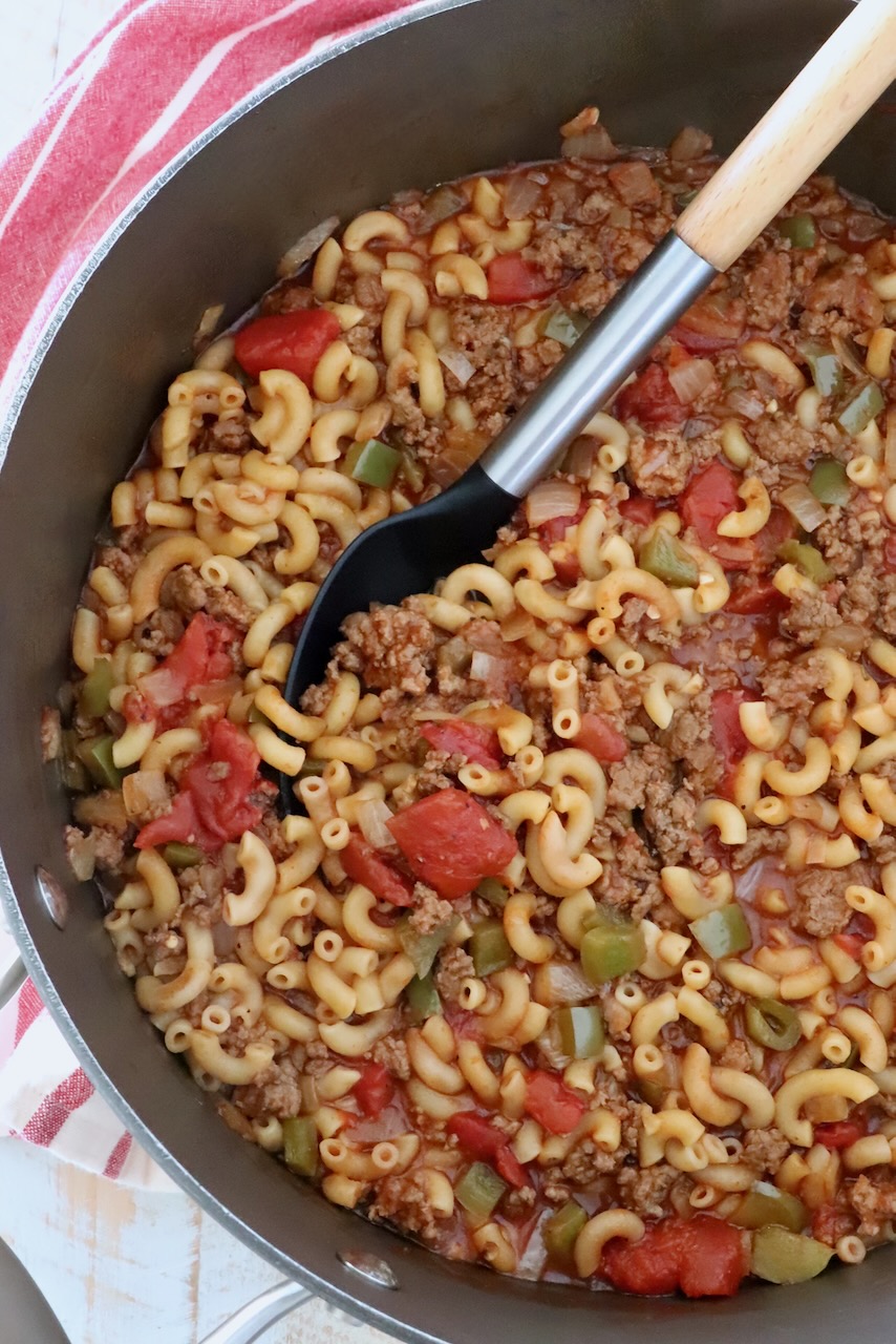 ground beef goulash in a pot with a serving spoon