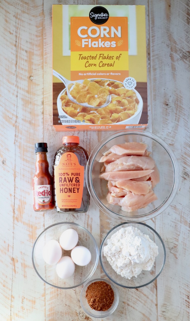 ingredients for hot honey chicken on a white wood board