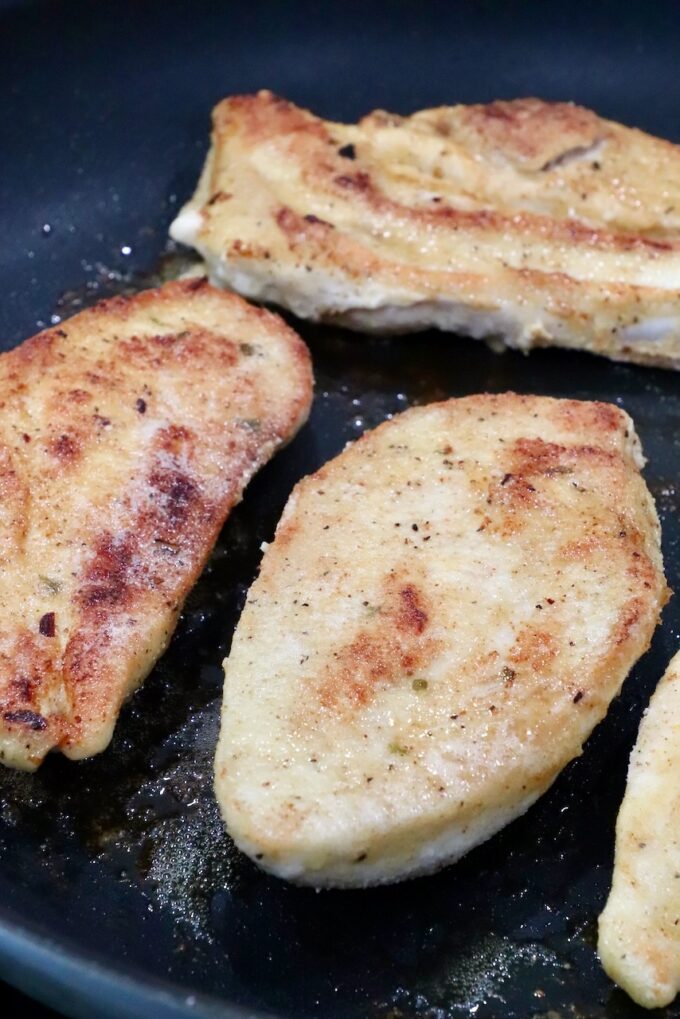 browned chicken breasts in a skillet