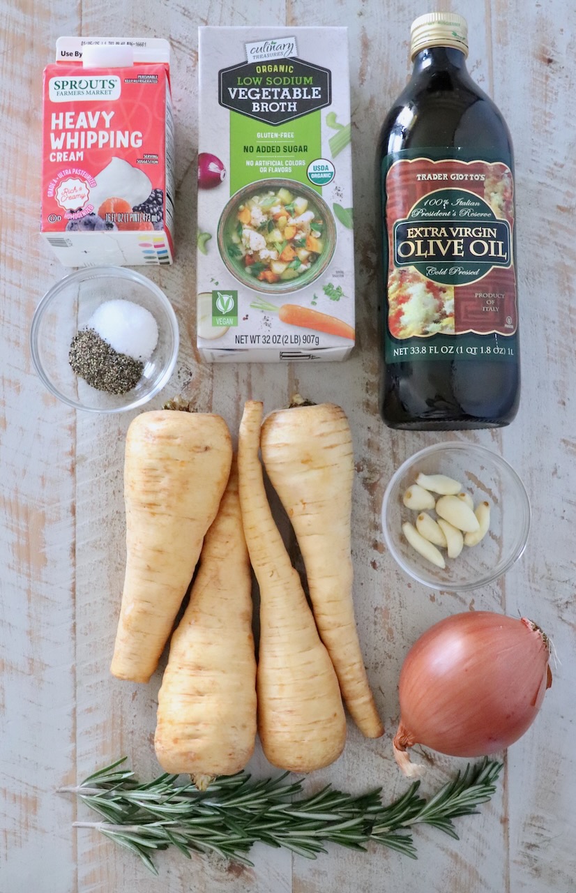 ingredients for parsnip soup on a white wood board