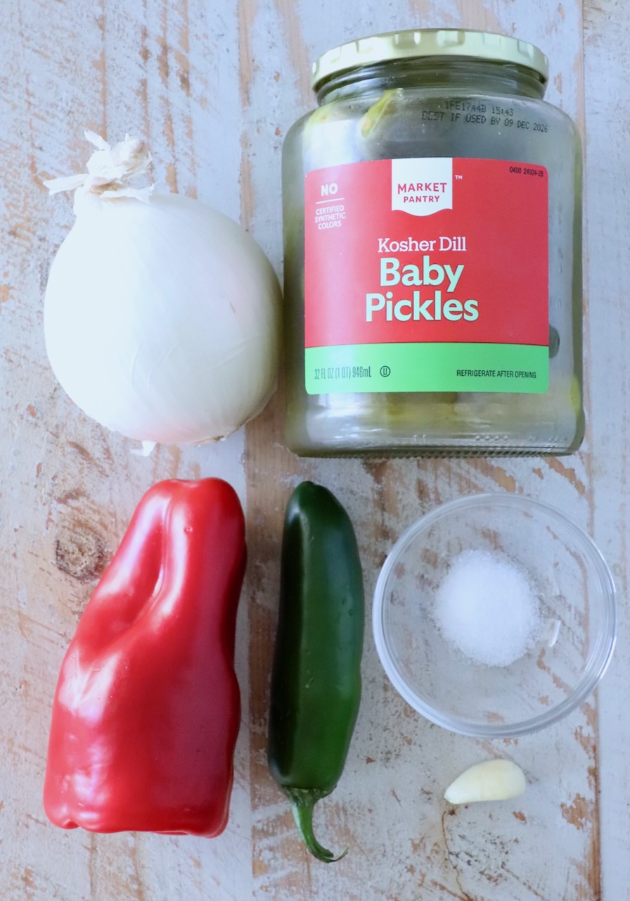 ingredients for pickle de gallo on a white wood board