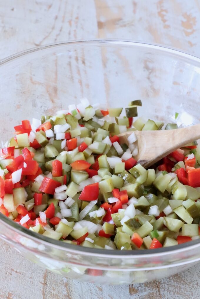 pickle de gallo mixed together in a glass bowl with a spoon