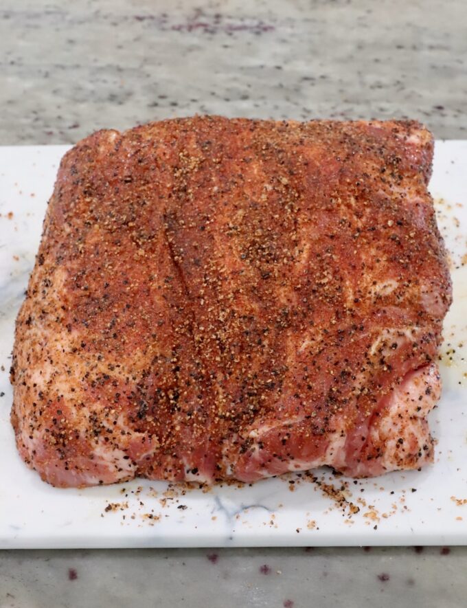 seasoned pork shoulder on a cutting board