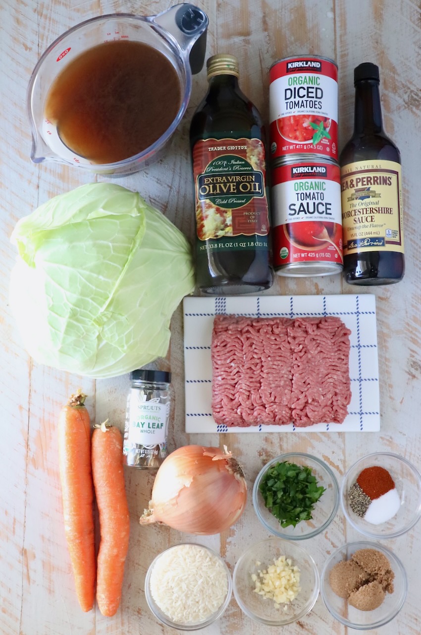 ingredients for cabbage roll soup on a white wood board