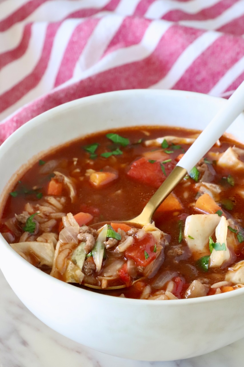 cabbage roll soup in a bowl with a spoon