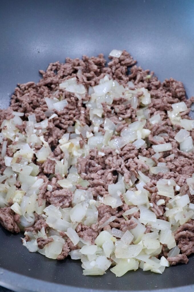 cooked ground beef and diced onions in a large pot