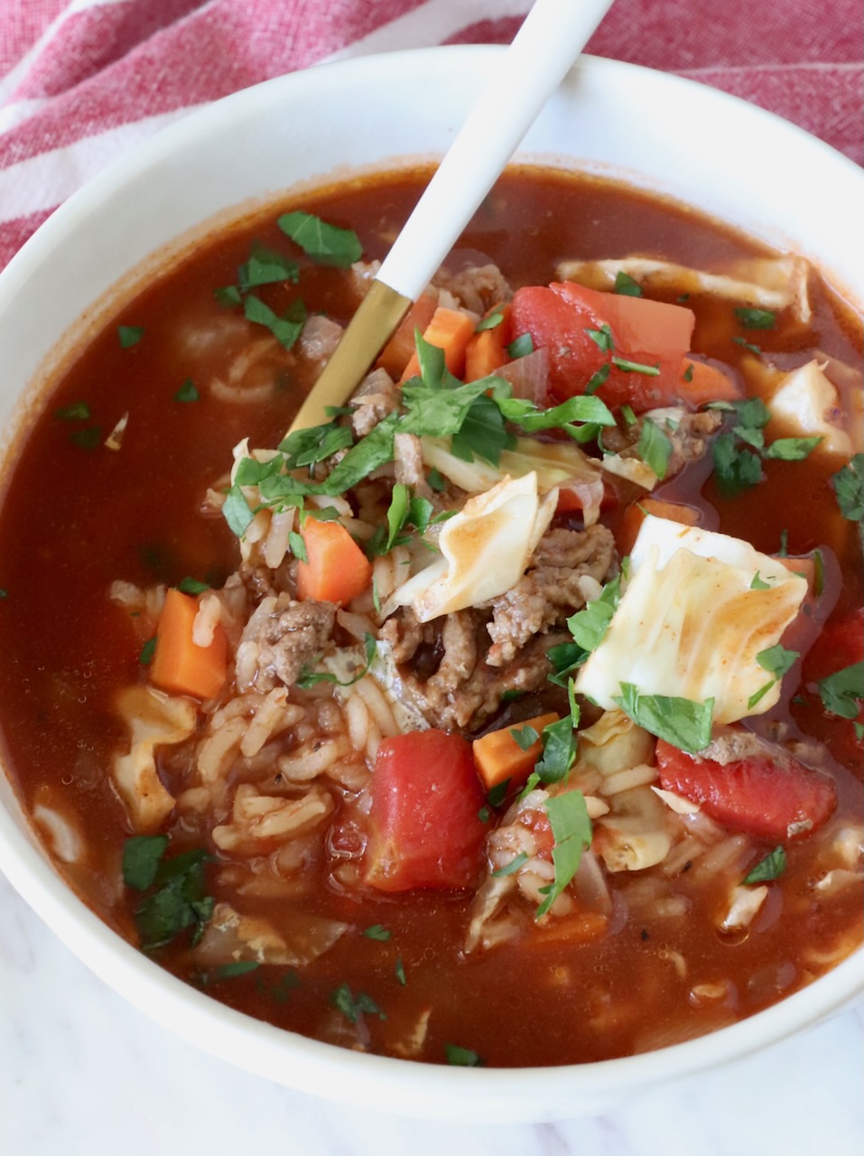 cabbage roll soup in a bowl with a spoon