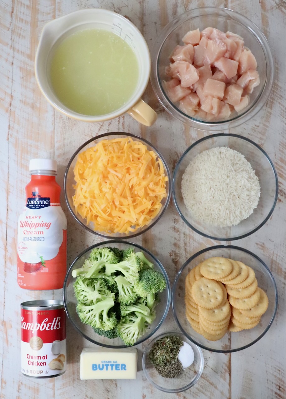 ingredients for chicken broccoli rice casserole on a white wood board