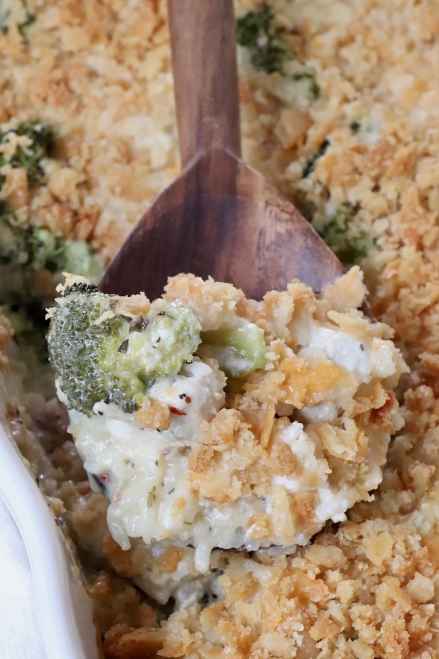 baked chicken broccoli rice casserole in a dish with a serving spoon