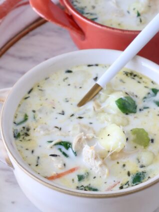 chicken gnocchi soup in bowls with a spoon