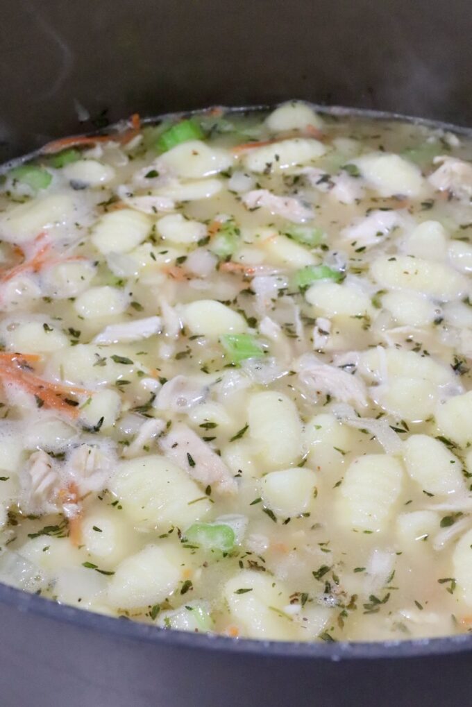 gnocchi, cooked chicken and diced veggies in seasoned broth in a large pot