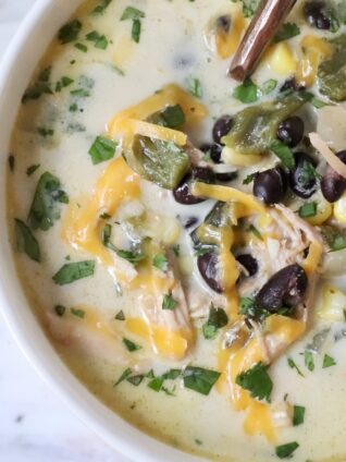 chicken poblano soup in a bowl with a spoon